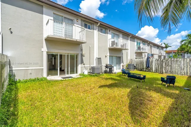 a view of backyard with swimming pool and sitting area