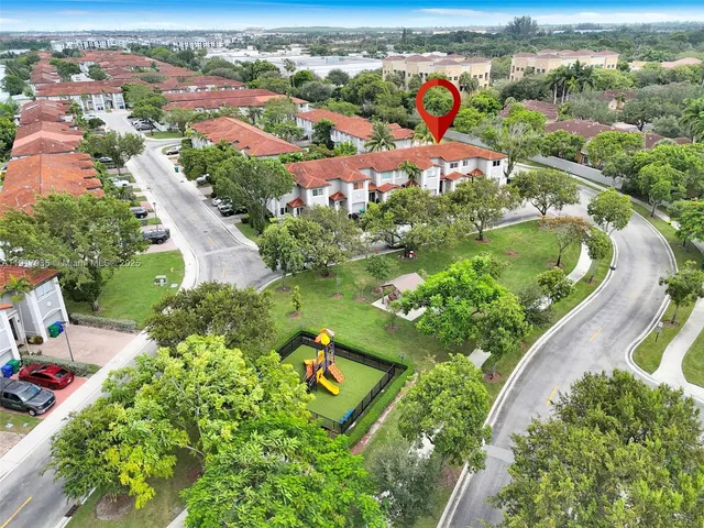an aerial view of residential houses with outdoor space