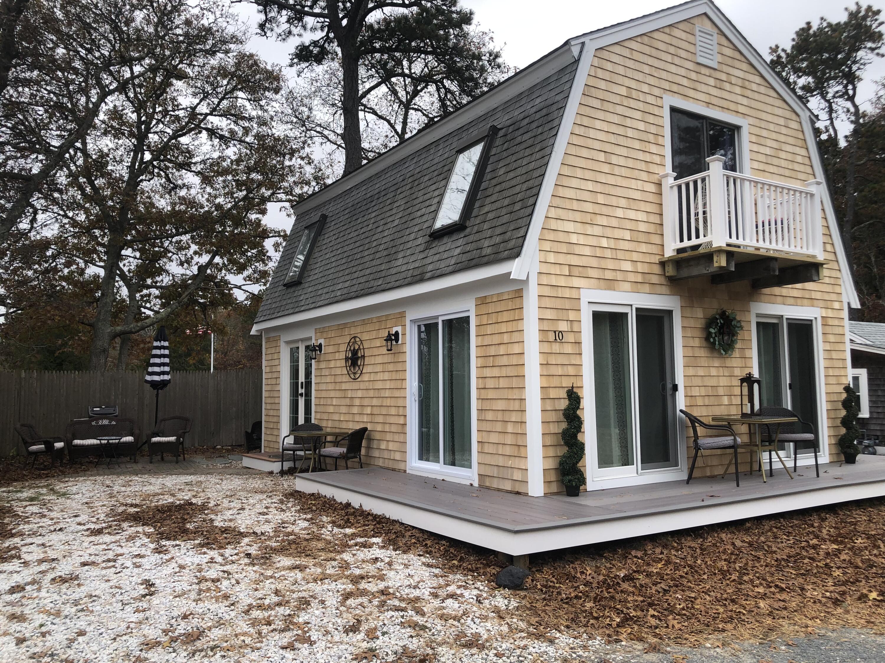 a view of a house with a yard and sitting area