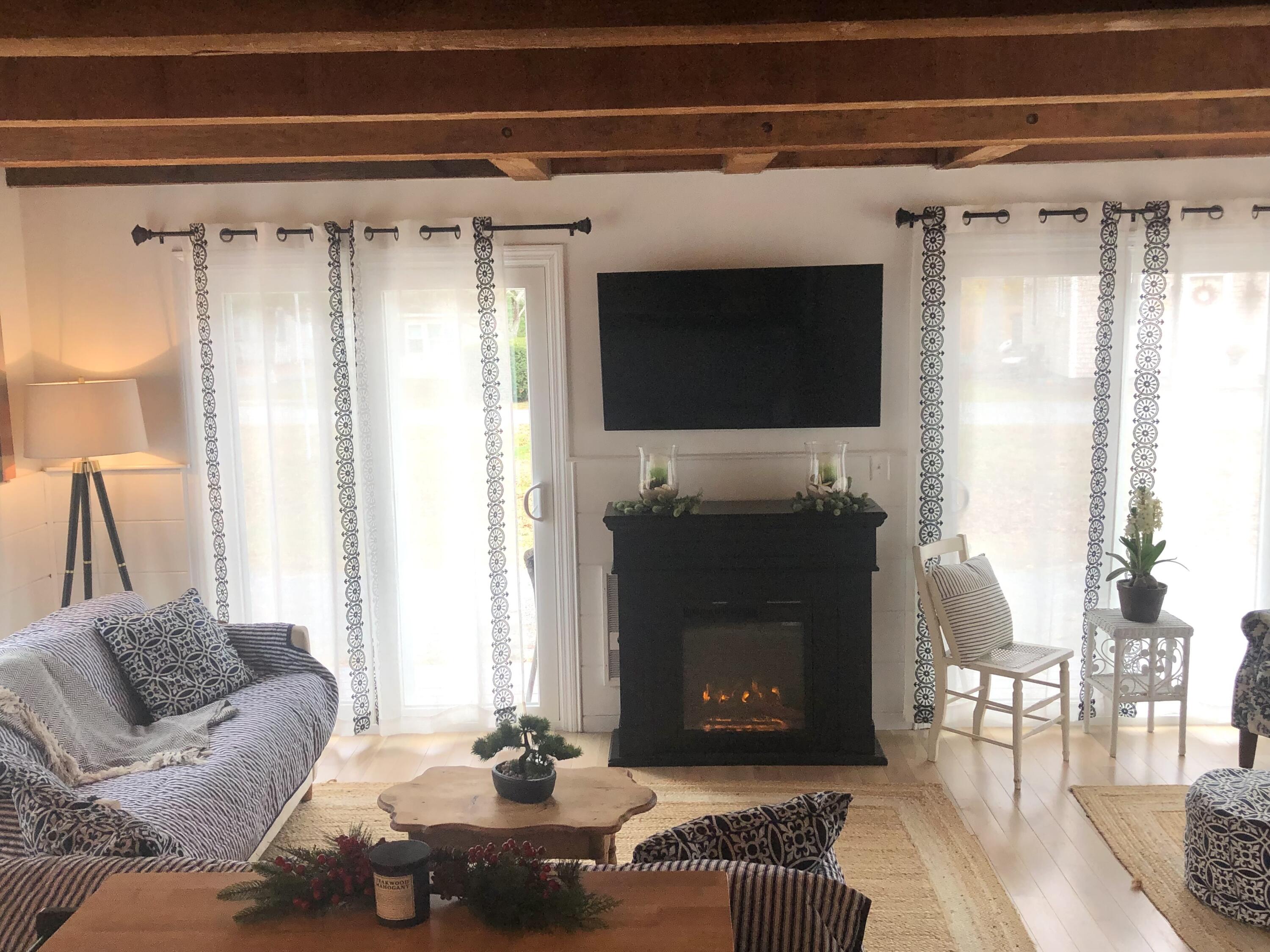 9 Bells Neck Road, Unit 10 West Harwich, MA 02671 - Photo 11 of 23 a living room with furniture and a fireplace