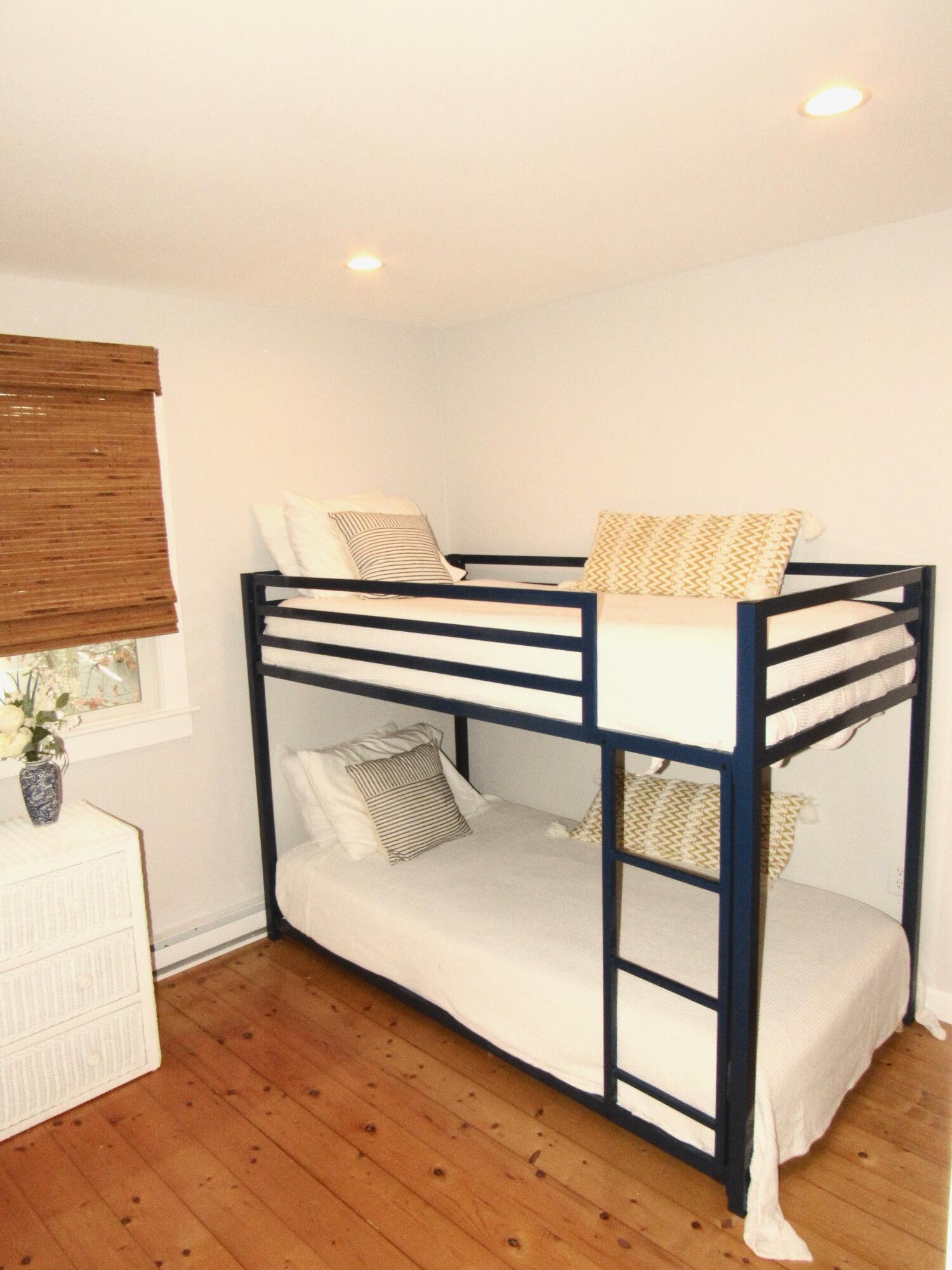 9 Bells Neck Road, Unit 10 West Harwich, MA 02671 - Photo 22 of 23 a view of a bedroom with furniture and wooden floor