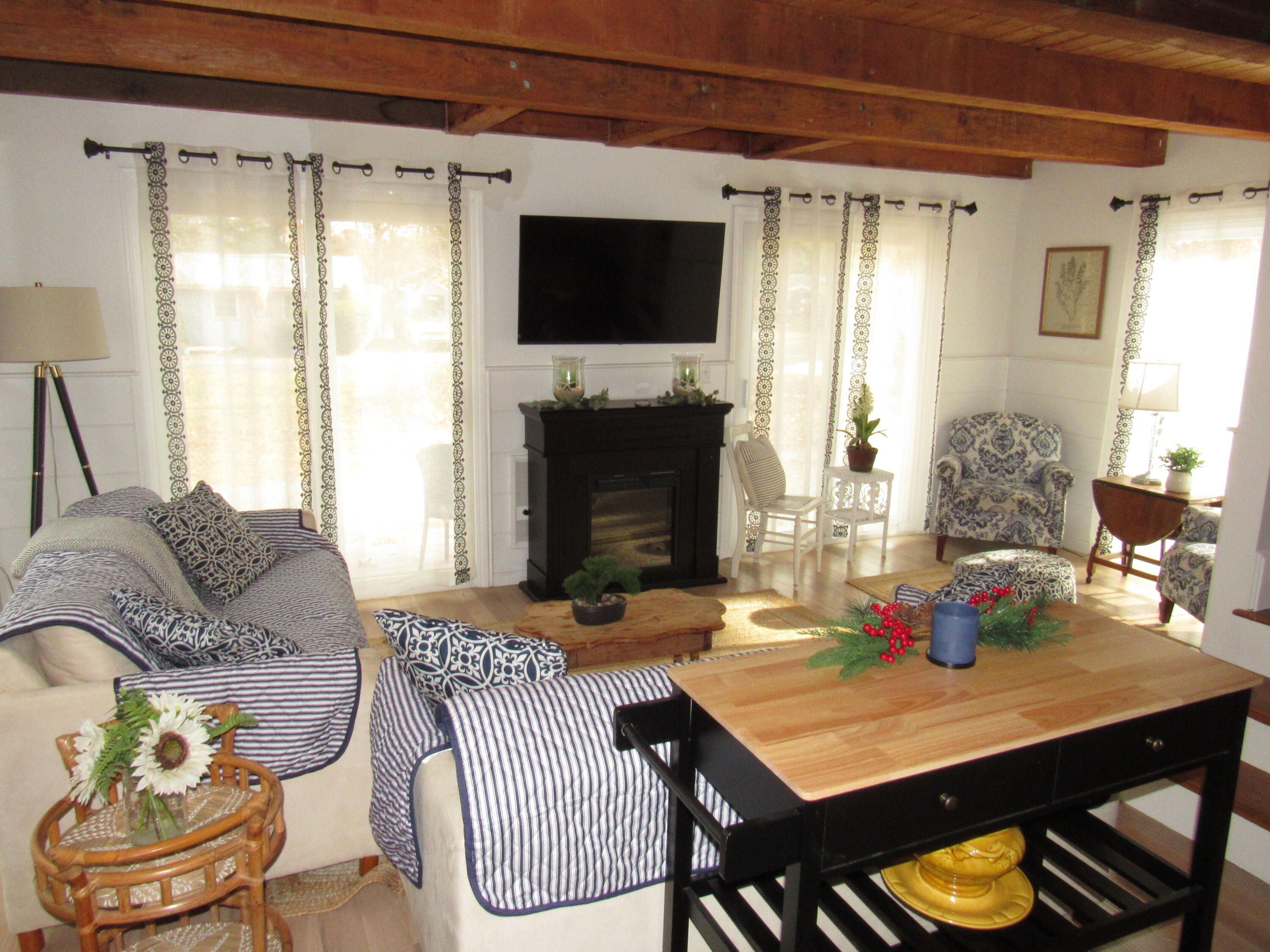 9 Bells Neck Road, Unit 10 West Harwich, MA 02671 - Photo 10 of 23 a living room with furniture a flat screen tv and a fireplace