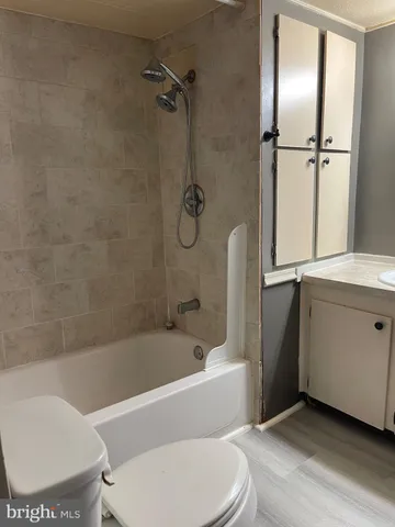 a bathroom with a toilet bathtub and shower