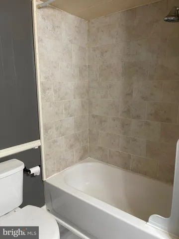 a white bath tub sitting next to a white toilet