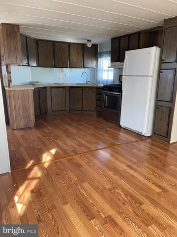 a kitchen with a refrigerator and a microwave