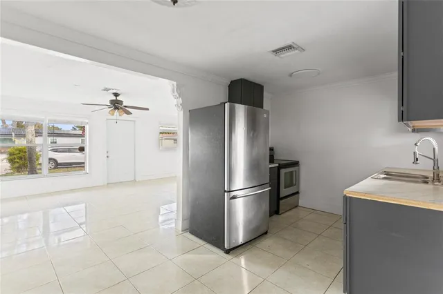 a kitchen with stainless steel appliances granite countertop a refrigerator and a sink