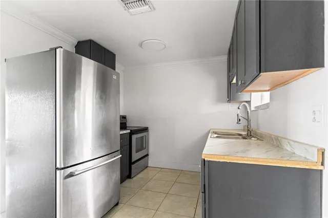 a kitchen with stainless steel appliances granite countertop a refrigerator and a sink