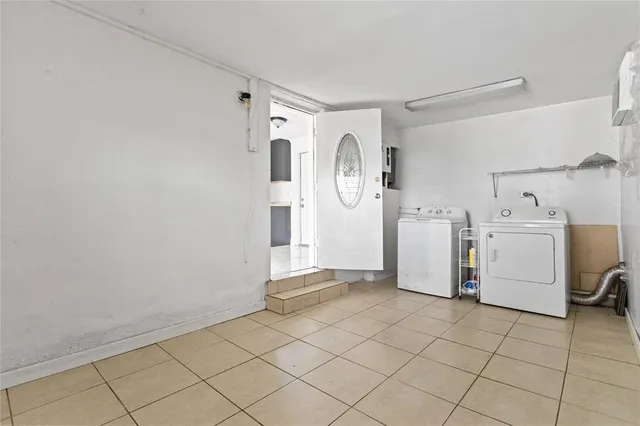 a view of a storage & utility room with dryer and washer