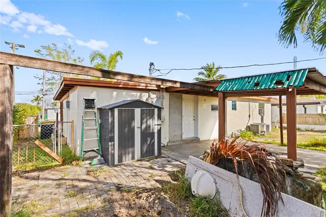 a view of a house with floor to ceiling windows and wooden roof