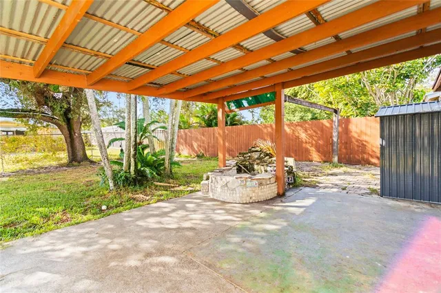 a view of a patio with a table and chairs under an umbrella