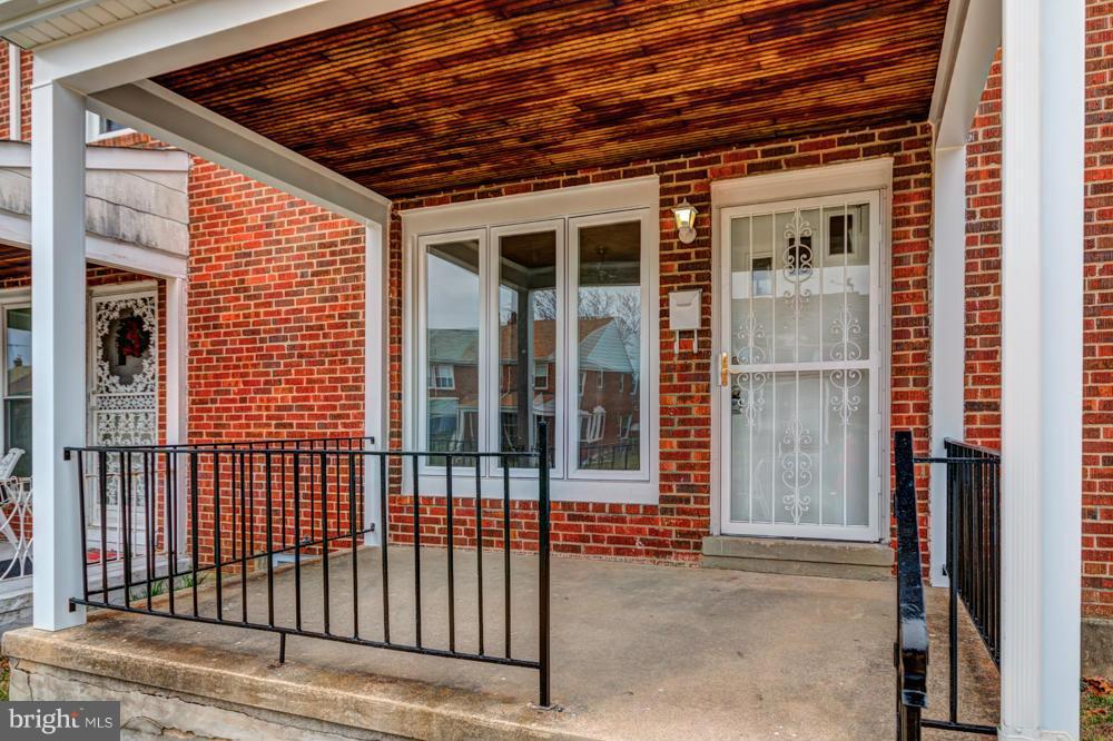6146 Marlora Road Baltimore, MD 21239 - Photo 23 of 27 a view of a porch with a table and chair