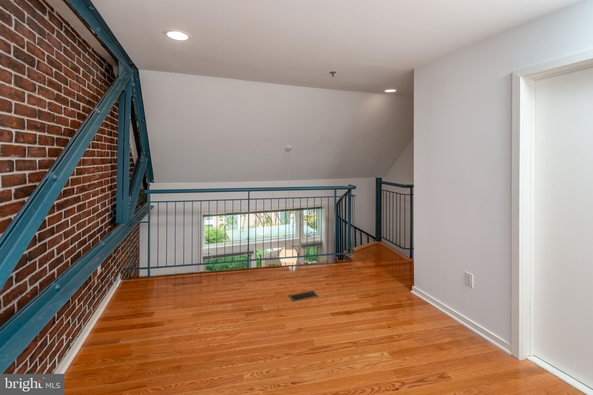 36 Moore Street, Unit 8 Princeton, NJ 08542 - Photo 17 of 35 a view of an empty room with wooden floor and a window