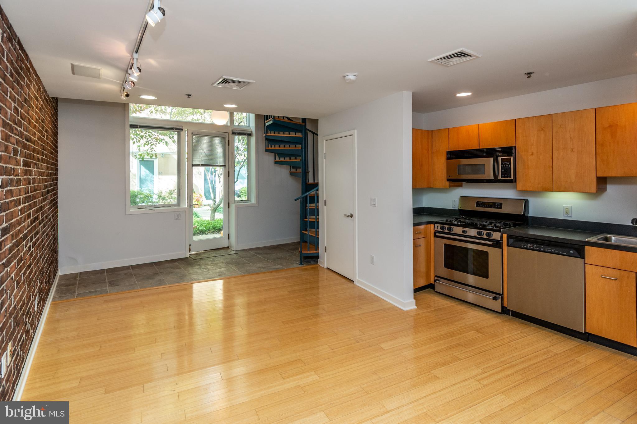 36 Moore Street, Unit 8 Princeton, NJ 08542 - Photo 31 of 35 a kitchen with granite countertop a stove and a refrigerator