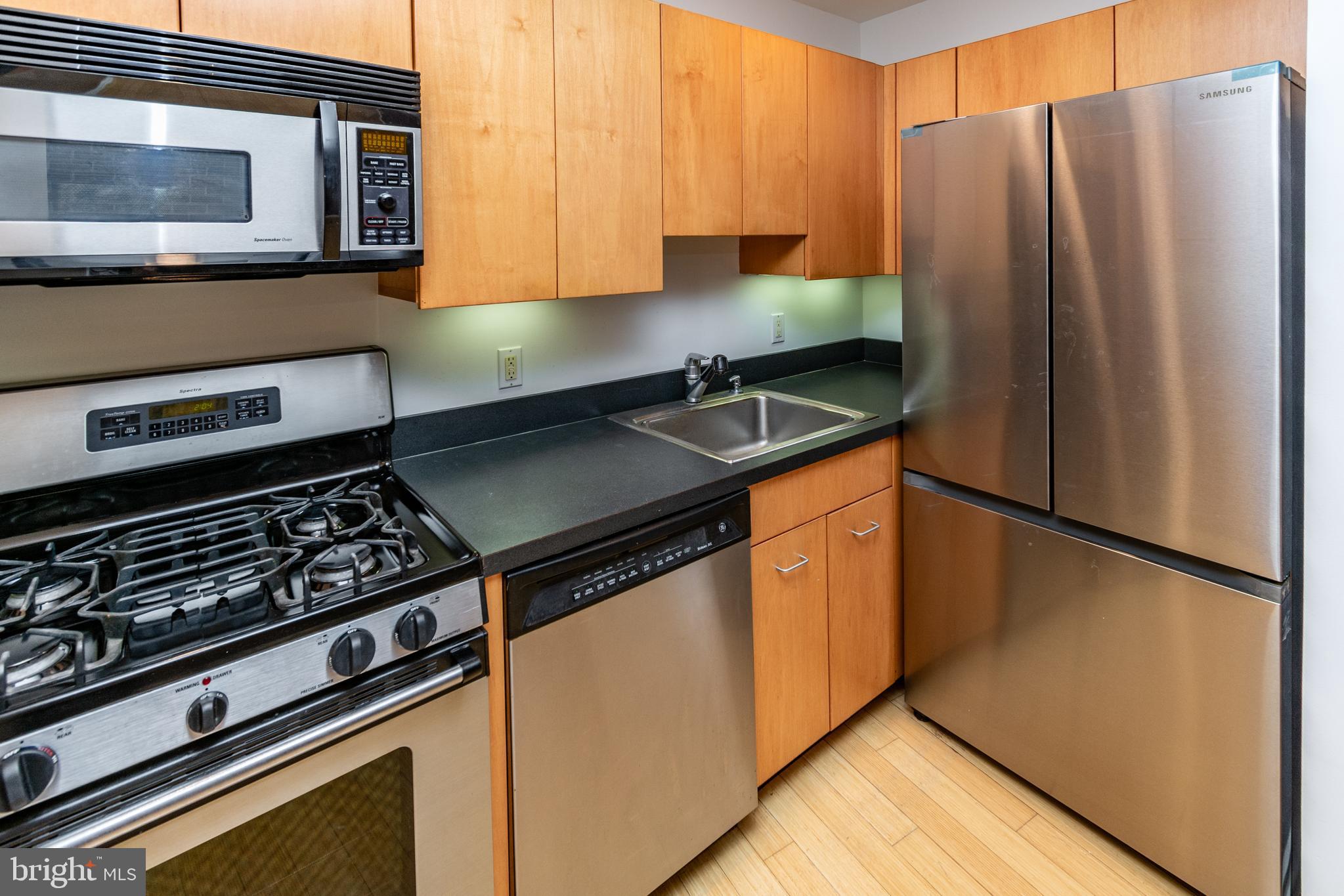 36 Moore Street, Unit 8 Princeton, NJ 08542 - Photo 6 of 35 a kitchen with granite countertop a refrigerator stove and microwave