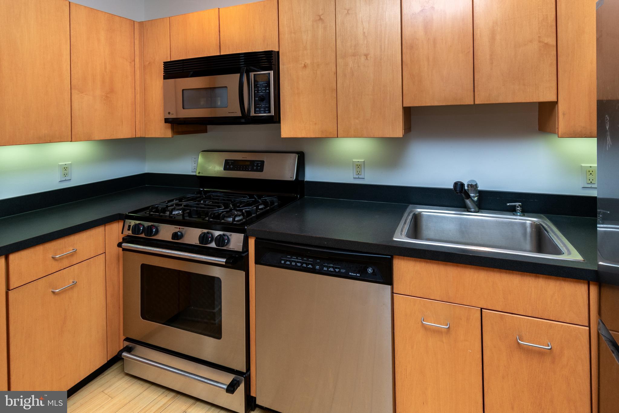 36 Moore Street, Unit 8 Princeton, NJ 08542 - Photo 7 of 35 a kitchen with granite countertop a stove sink and cabinets