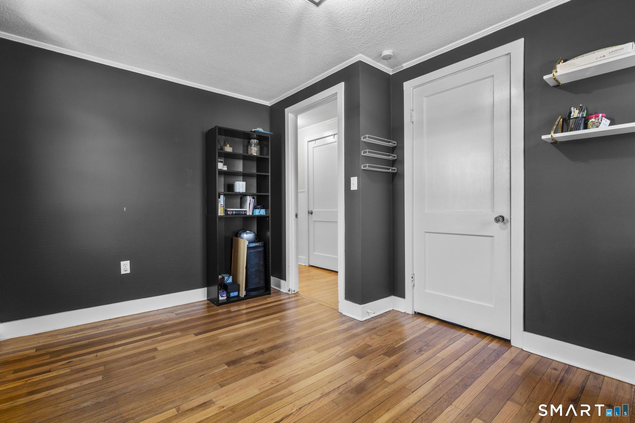 31 Flyers Drive Norwich, CT 06360 - Photo 16 of 30 a view of an empty room with wooden floor and closet