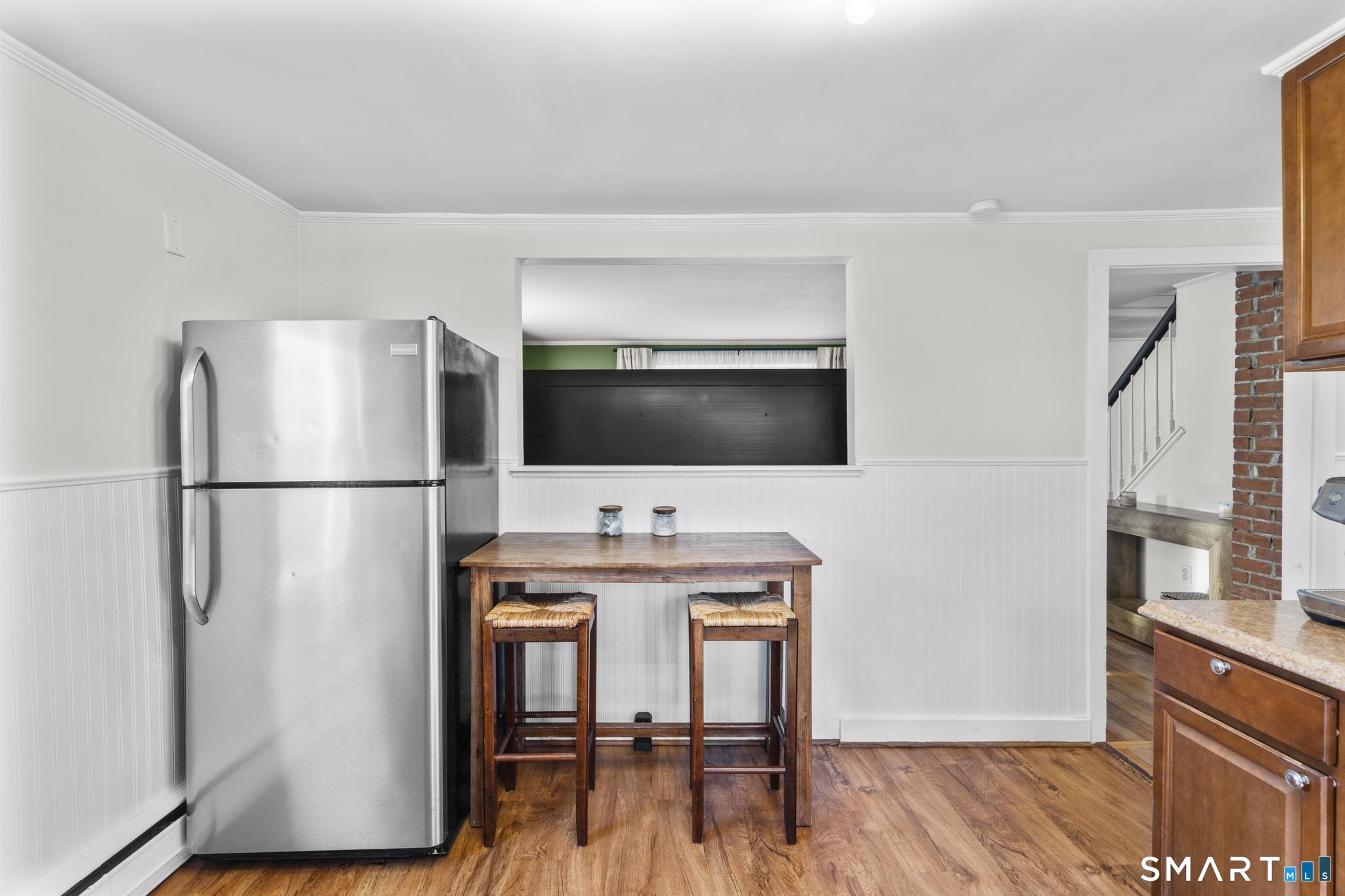 31 Flyers Drive Norwich, CT 06360 - Photo 19 of 30 a living room with a flat screen tv furniture and a refrigerator