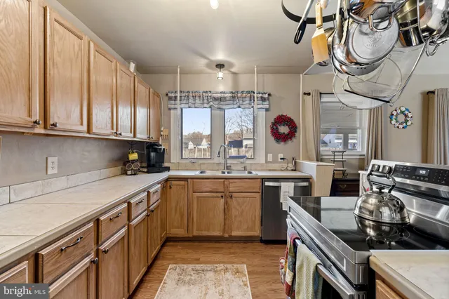 a kitchen with a sink cabinets and window