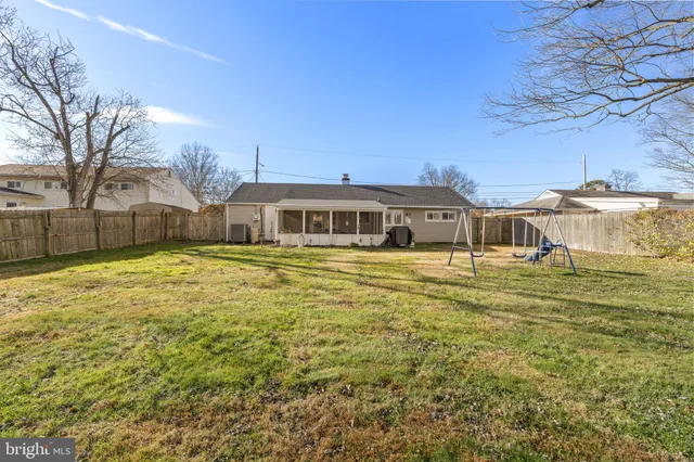 a house view with swimming pool in front of it