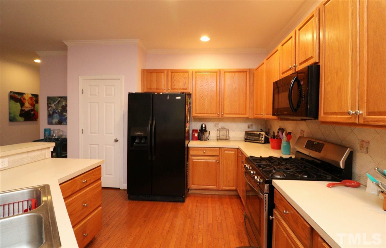 4703 Malone Court Raleigh, NC 27616 - Photo 11 of 30 a kitchen with stainless steel appliances granite countertop a refrigerator stove top oven and sink