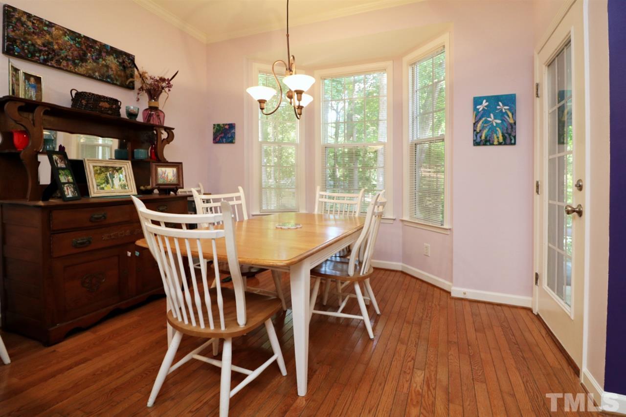 4703 Malone Court Raleigh, NC 27616 - Photo 12 of 30 a view of a dining room with furniture window and wooden floor