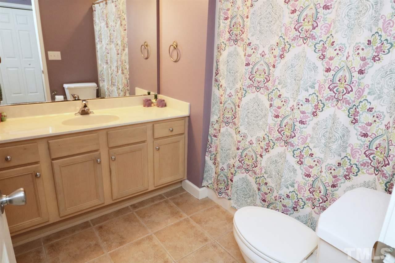 4703 Malone Court Raleigh, NC 27616 - Photo 18 of 30 a bathroom with a sink toilet and mirror