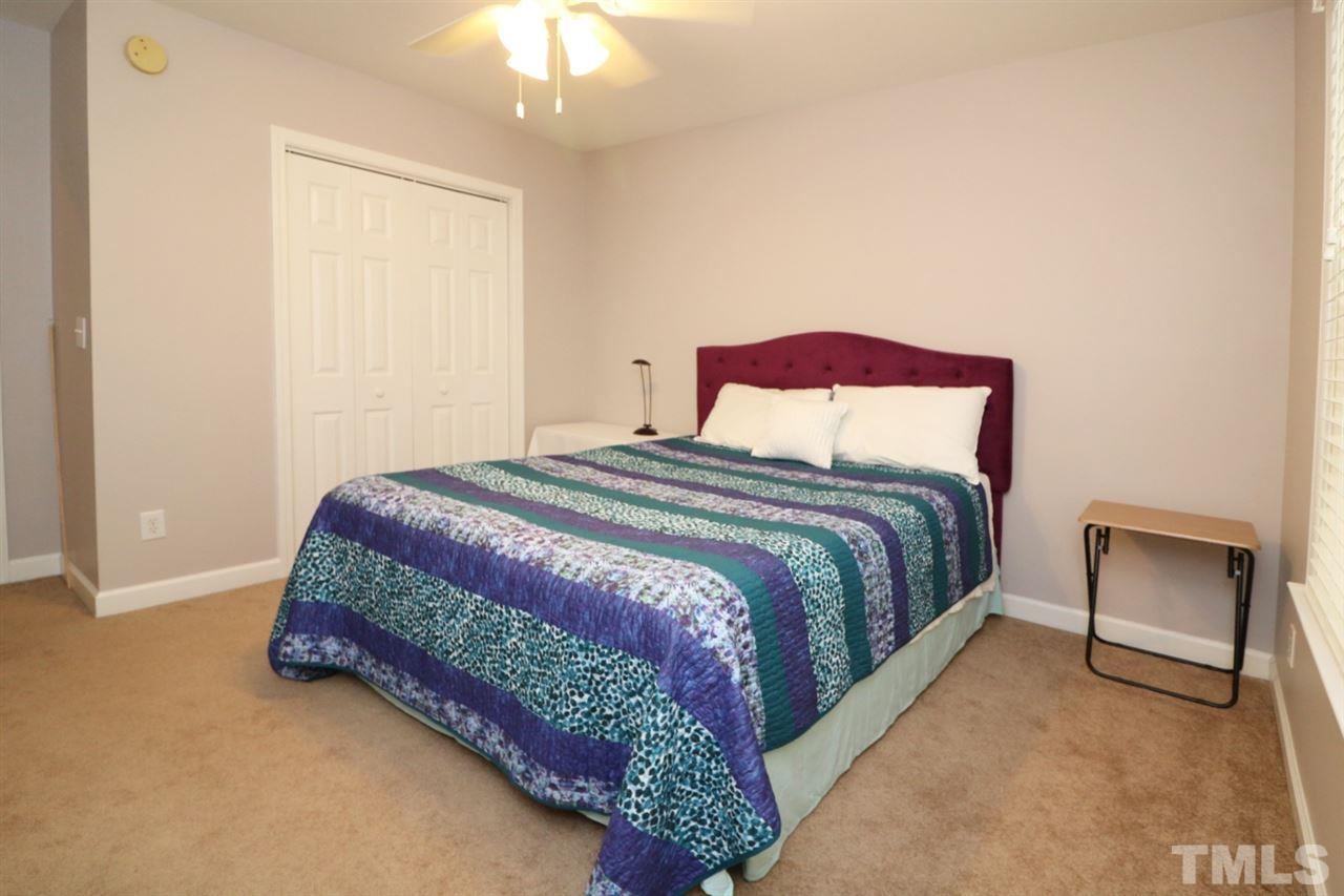4703 Malone Court Raleigh, NC 27616 - Photo 20 of 30 a bedroom with a bed and a chair