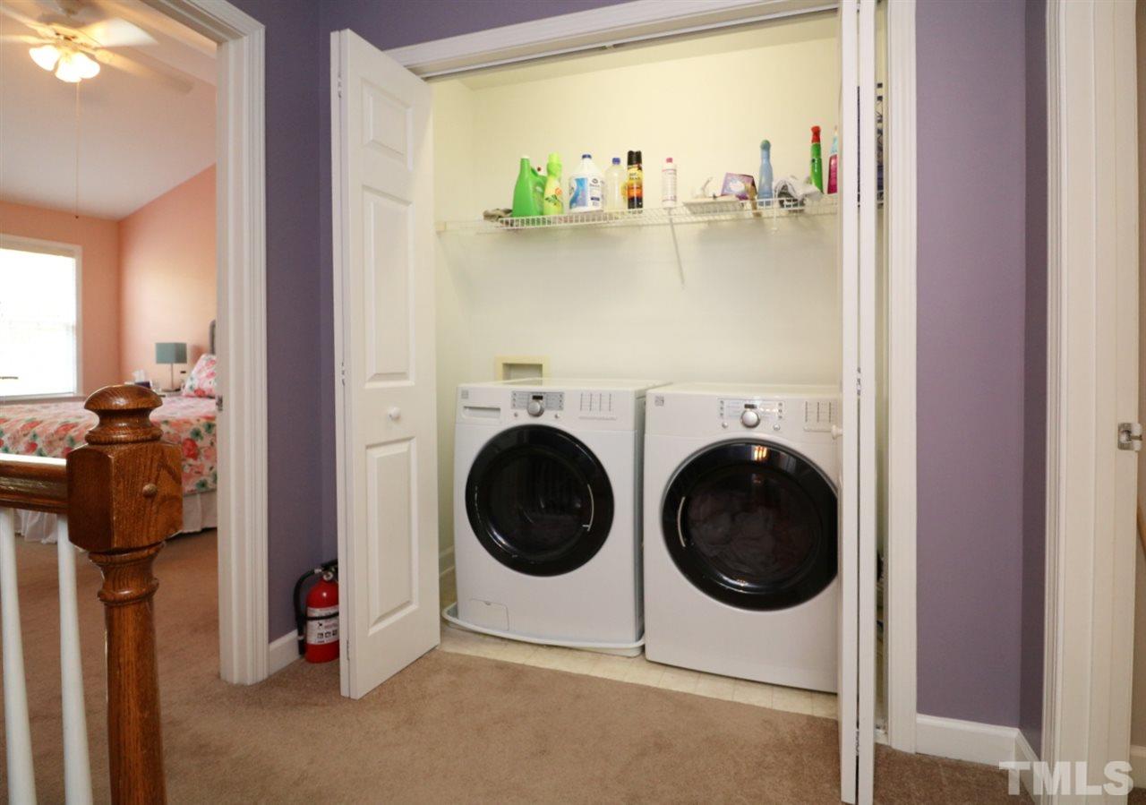 4703 Malone Court Raleigh, NC 27616 - Photo 22 of 30 a utility room with dryer washer and a view of living room