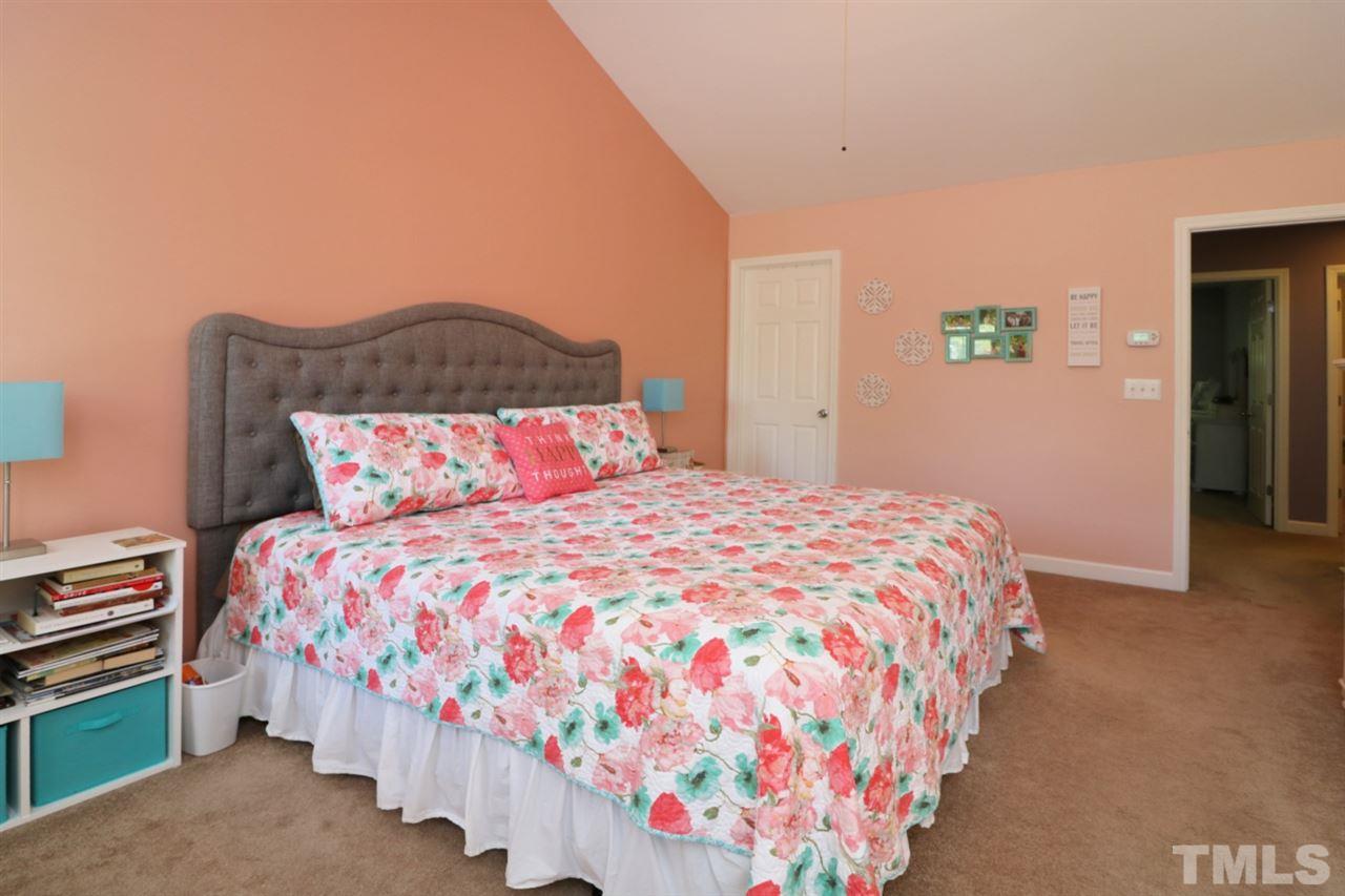 4703 Malone Court Raleigh, NC 27616 - Photo 24 of 30 a bedroom with a bed and a lamp on dresser