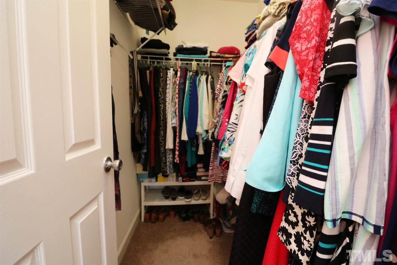 4703 Malone Court Raleigh, NC 27616 - Photo 26 of 30 a view of walk in closet with clothes and shoes