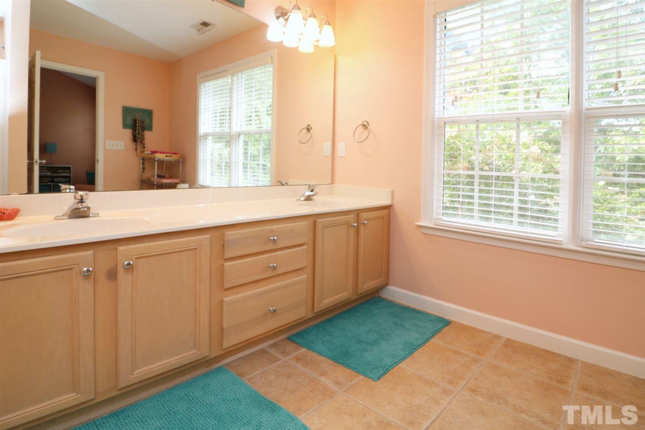 4703 Malone Court Raleigh, NC 27616 - Photo 27 of 30 a spacious bathroom with a sink mirror and a next to a window
