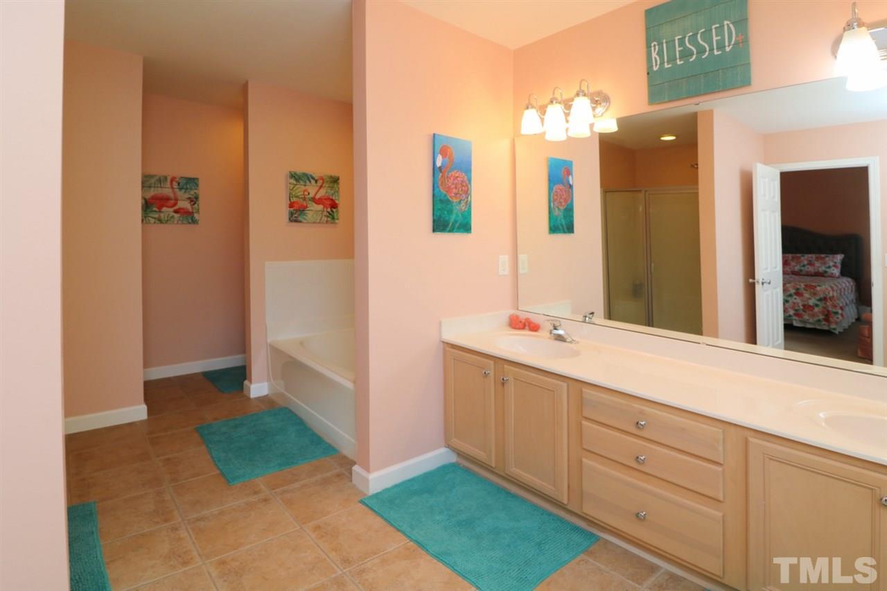 4703 Malone Court Raleigh, NC 27616 - Photo 28 of 30 a bathroom with a sink and a mirror