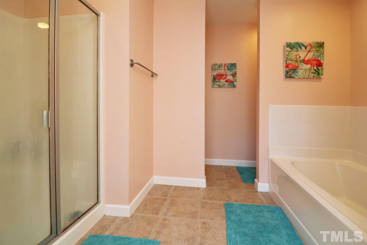 4703 Malone Court Raleigh, NC 27616 - Photo 29 of 30 a bathroom with a bathtub and a shower