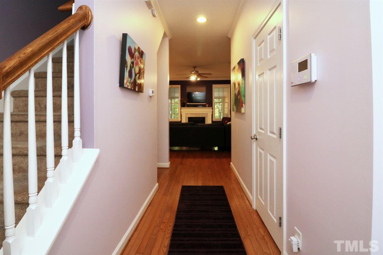 4703 Malone Court Raleigh, NC 27616 - Photo 4 of 30 a view of a hallway with wooden floor and staircase