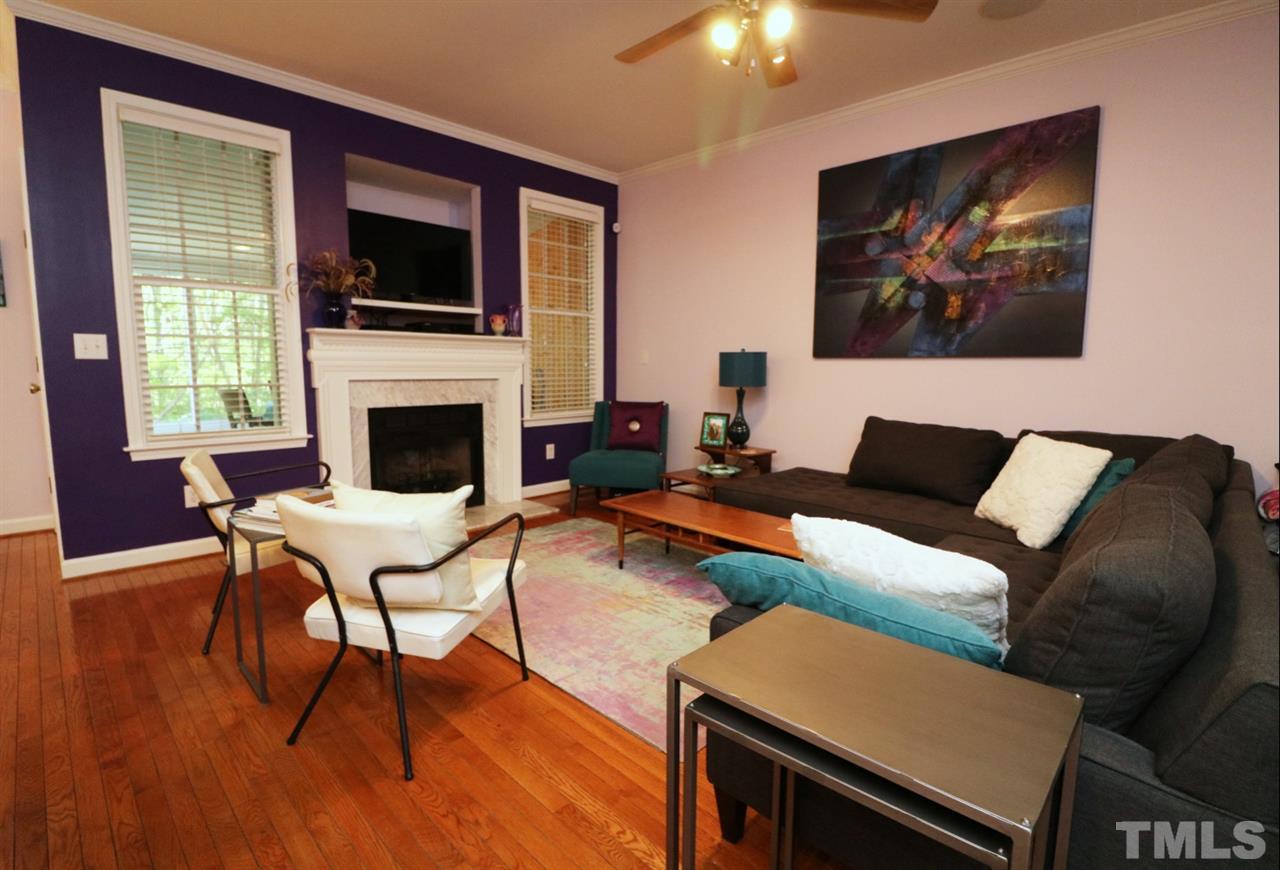 4703 Malone Court Raleigh, NC 27616 - Photo 6 of 30 a living room with furniture a fireplace and a flat screen tv
