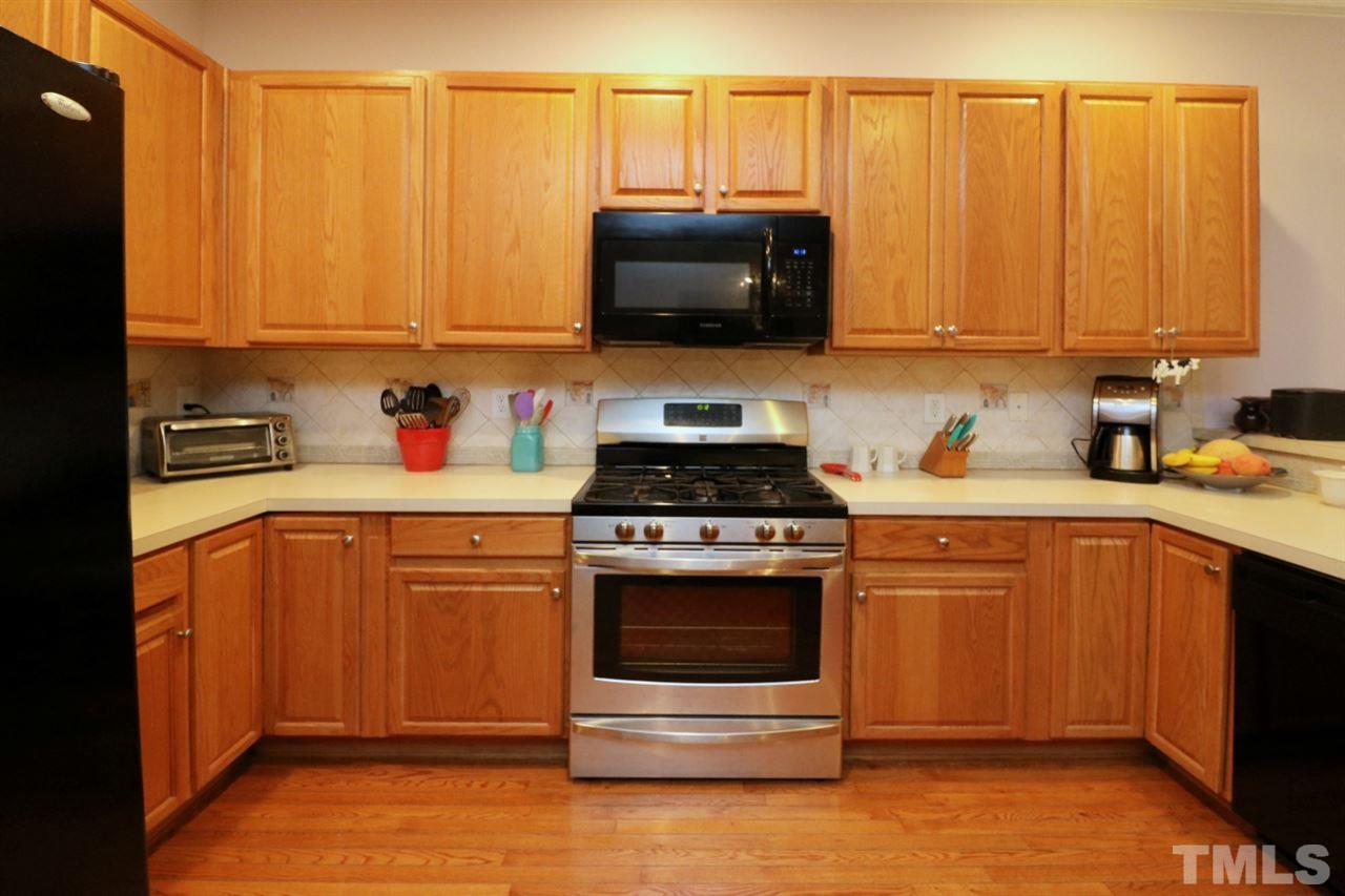 4703 Malone Court Raleigh, NC 27616 - Photo 9 of 30 a kitchen with stainless steel appliances a stove a sink a microwave and cabinets