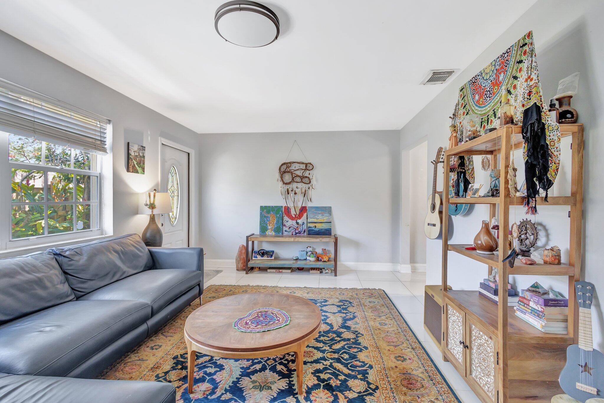 227 Northeast 12th Street, Unit 2 Delray Beach, FL 33444 - Photo 12 of 24 a living room with furniture and a rug