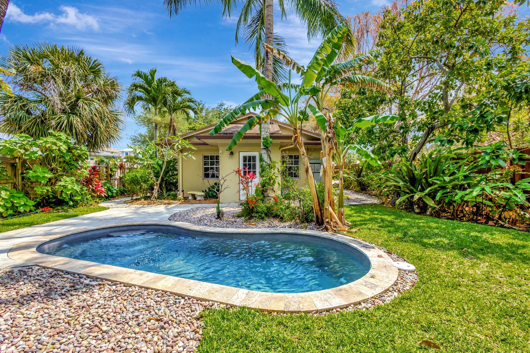227 Northeast 12th Street, Unit 2 Delray Beach, FL 33444 - Photo 21 of 24 a view of a house with a small yard and sitting area