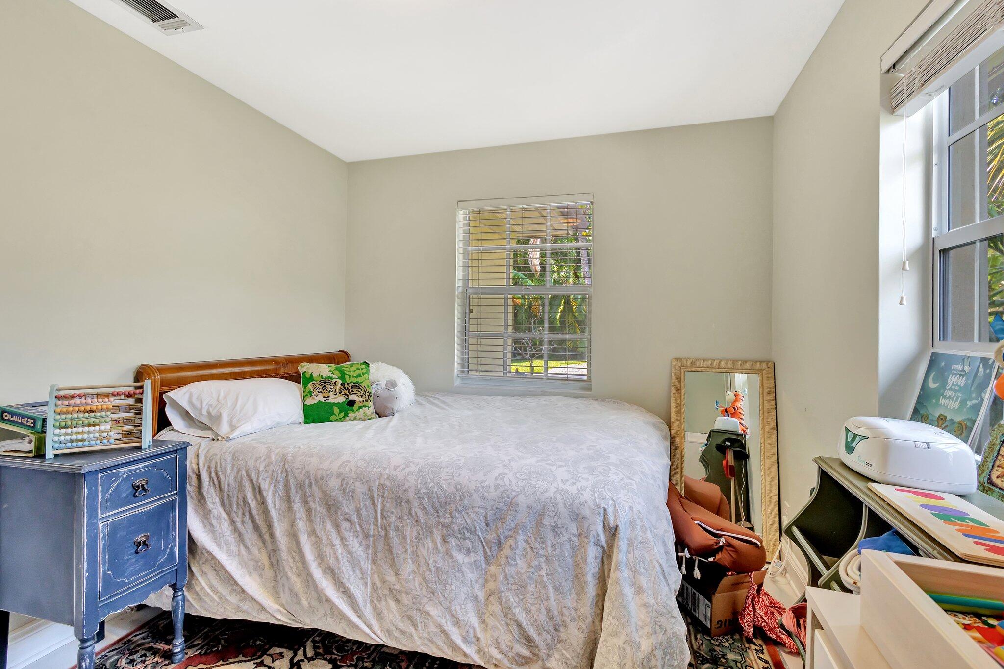 227 Northeast 12th Street, Unit 2 Delray Beach, FL 33444 - Photo 6 of 24 a bedroom with a bed and a window