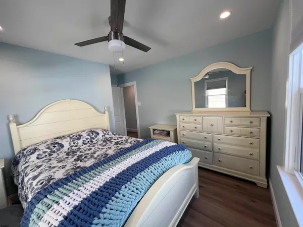 a bedroom with a bed and a dresser