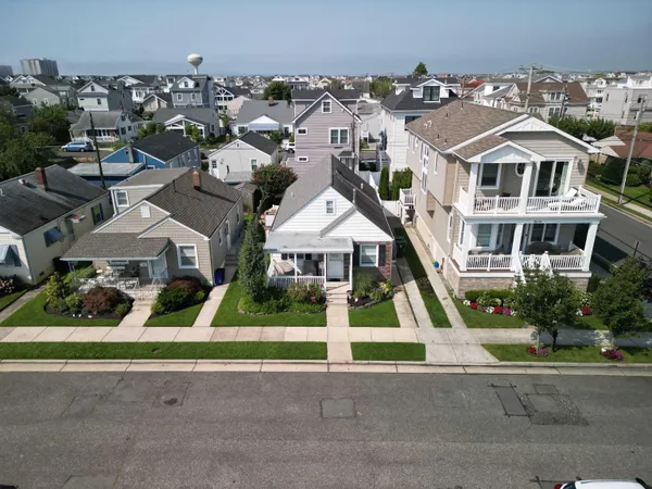 an aerial view of residential houses with street