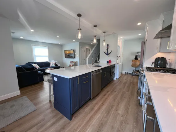 a kitchen with sink stove and cabinets