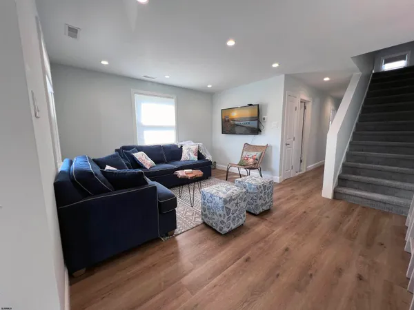 a kitchen with a sink a refrigerator and wooden floor