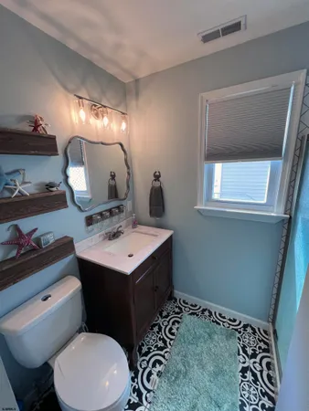 a bathroom with a sink toilet and mirror