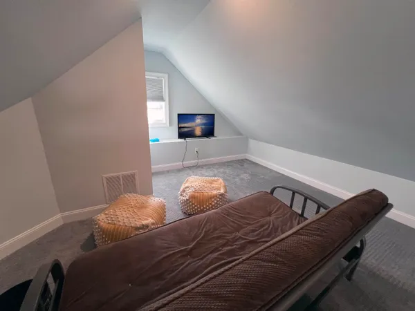 a bedroom with furniture and a window