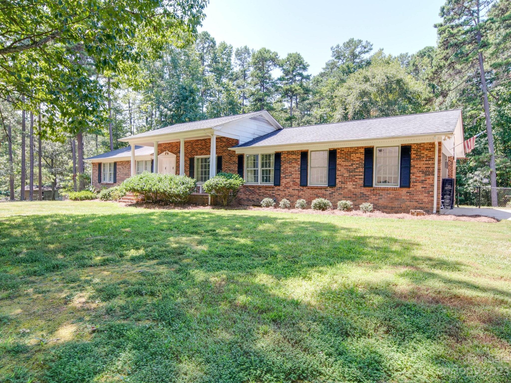 2845 Puetts Chapel Road Bessemer City, NC 28016 - Photo 2 of 15 a front view of a house with a garden