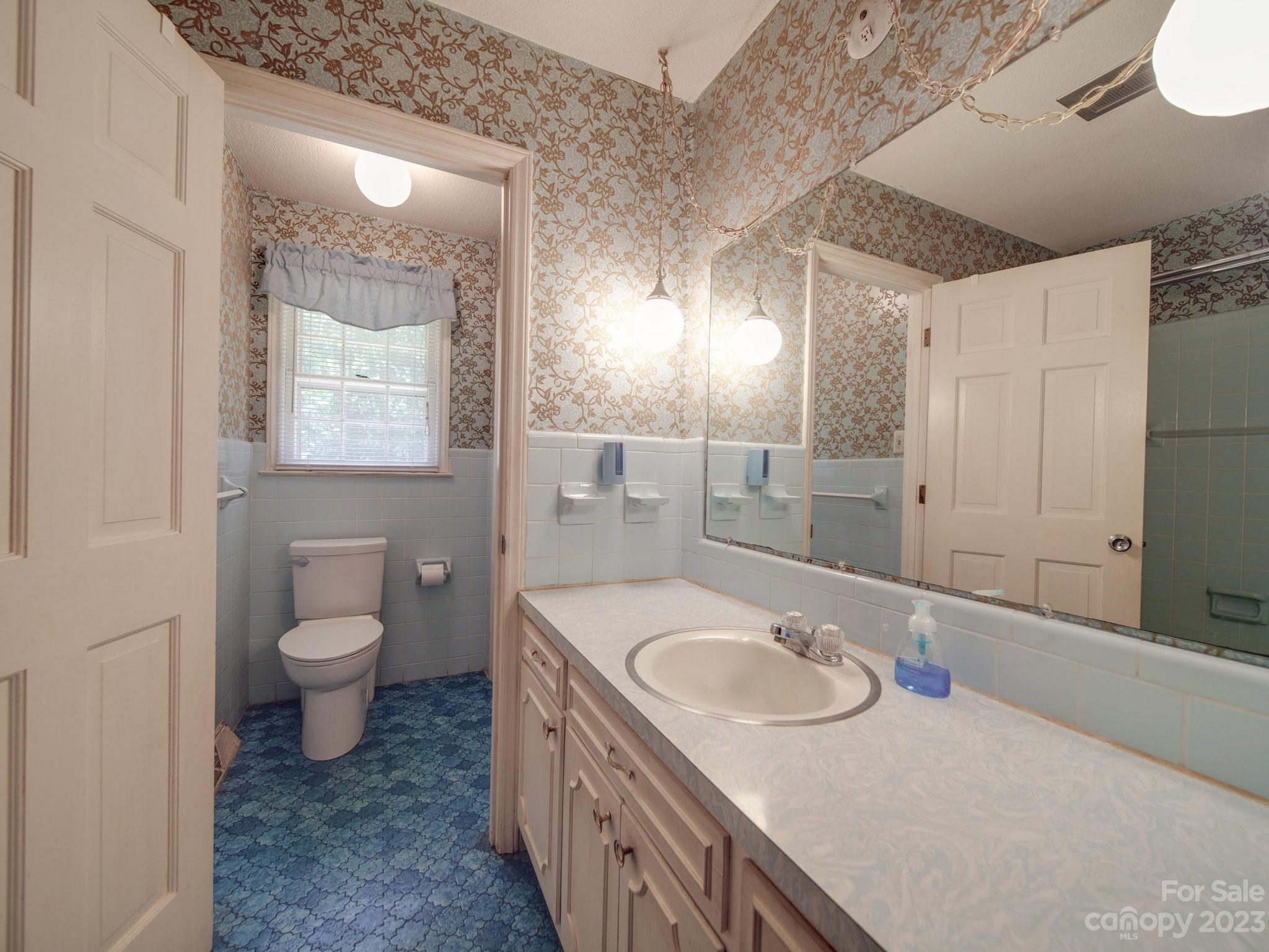 2845 Puetts Chapel Road Bessemer City, NC 28016 - Photo 8 of 15 a bathroom with a granite countertop sink toilet and a mirror