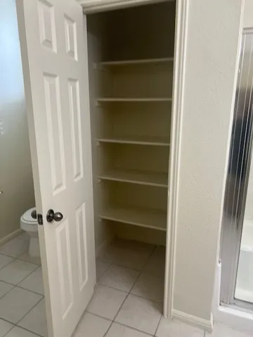 a white toilet and tub sitting next to a bathroom sink