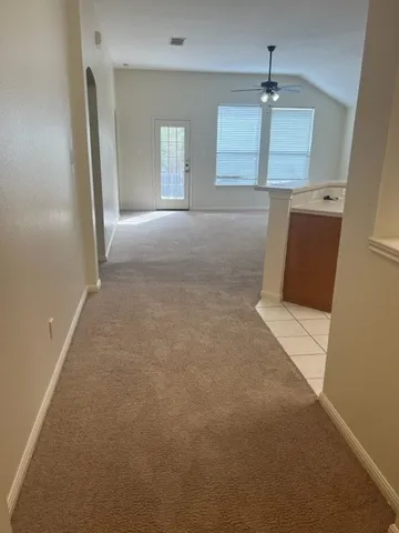 an empty room with windows and cabinet
