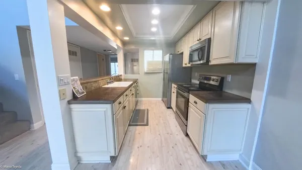 a kitchen with stainless steel appliances granite countertop a stove and a refrigerator